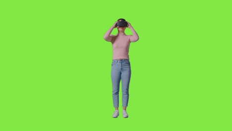 Full-Length-Shot-Of-Woman-Wearing-Virtual-Reality-Headset-And-Interacting-Against-Green-Screen-Studio-Background